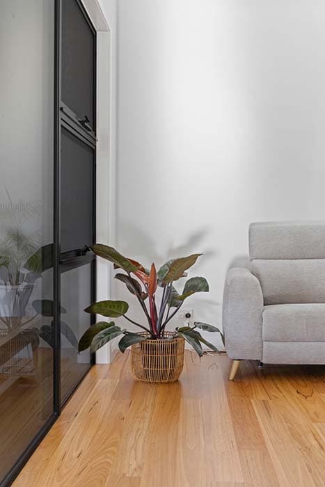 Modern living space renovation in Canberra, Australia with timber flooring and stylish decor.