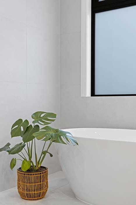 Modern bathroom renovation in Canberra with freestanding tub and natural elements