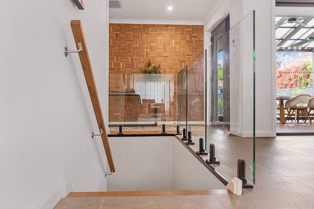 Modern staircase with glass balustrade in a Canberra home renovation