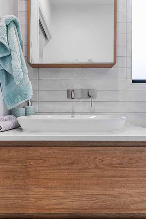 Modern bathroom renovation in Canberra with wooden vanity and sleek sink