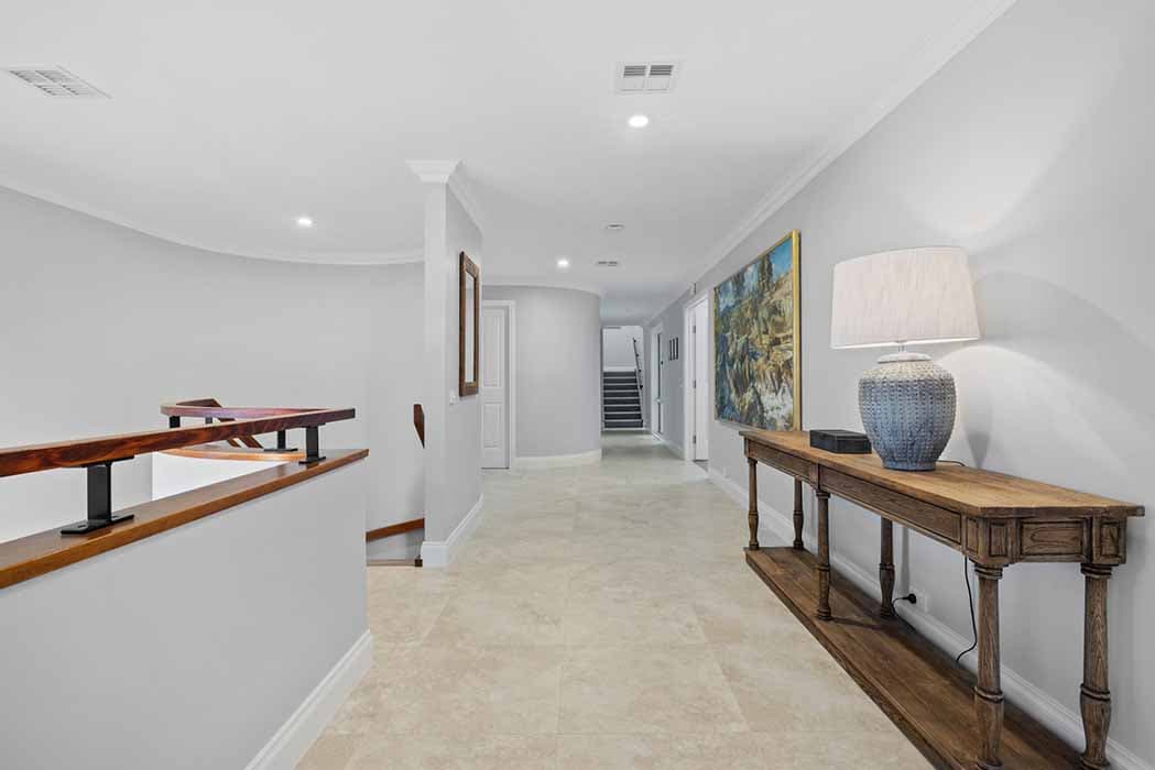 Stylish hallway renovation in Canberra, Australia with modern finishes and warm accents.