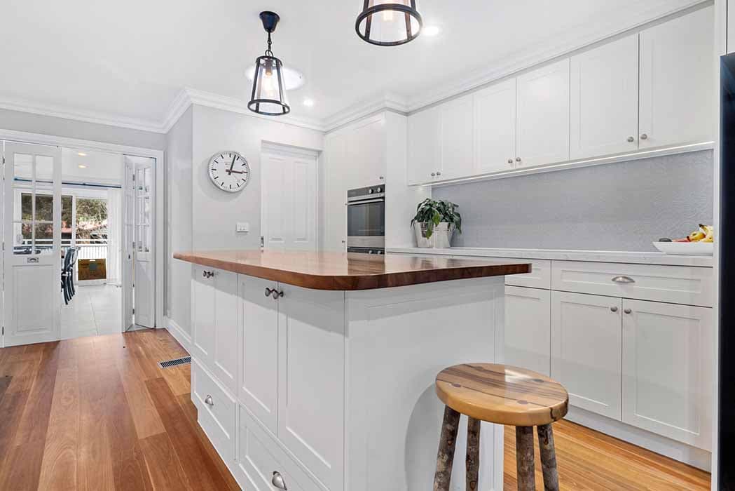 Modern kitchen renovation in Canberra, Australia with timber island and white cabinetry.