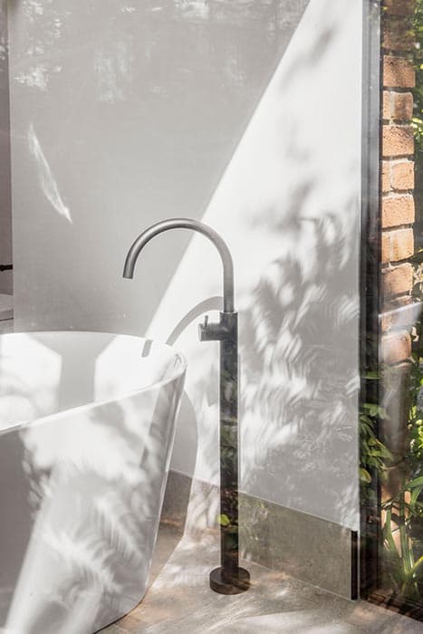 Modern bathroom renovation in Canberra with freestanding tub and stylish faucet.