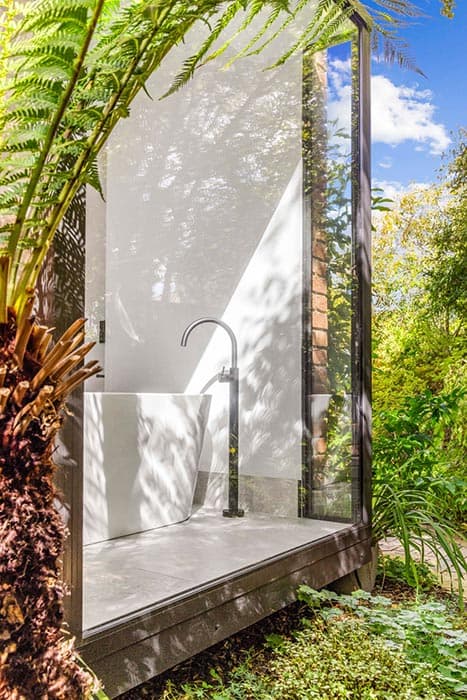 Outdoor bathroom renovation in Canberra, Australia with modern design and lush greenery.