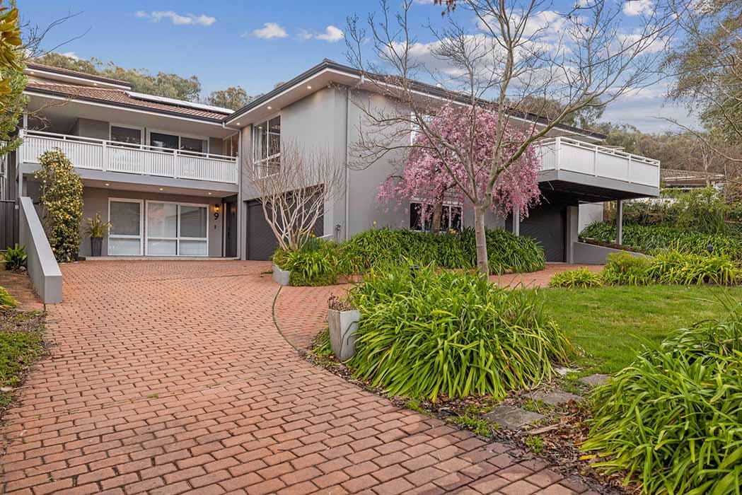 Modern home renovation in Canberra, showcasing elegant design and lush landscaping.