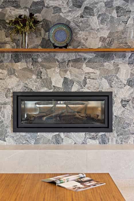 Modern stone feature wall and fireplace in a Canberra home renovation