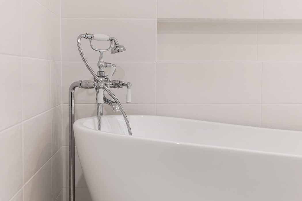 Modern bathroom renovation in Canberra with freestanding tub and chrome fixtures