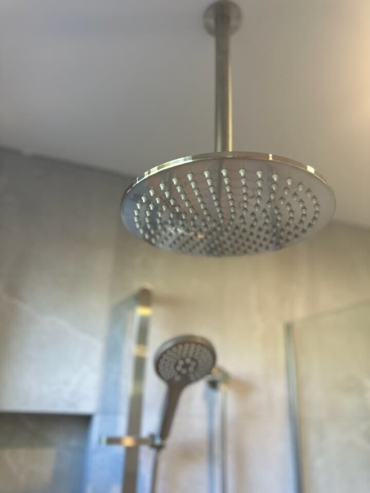 Modern bathroom renovation in Canberra with stylish rain shower fixtures