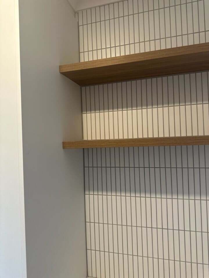Modern wooden shelves with striped tiles in a Canberra renovation