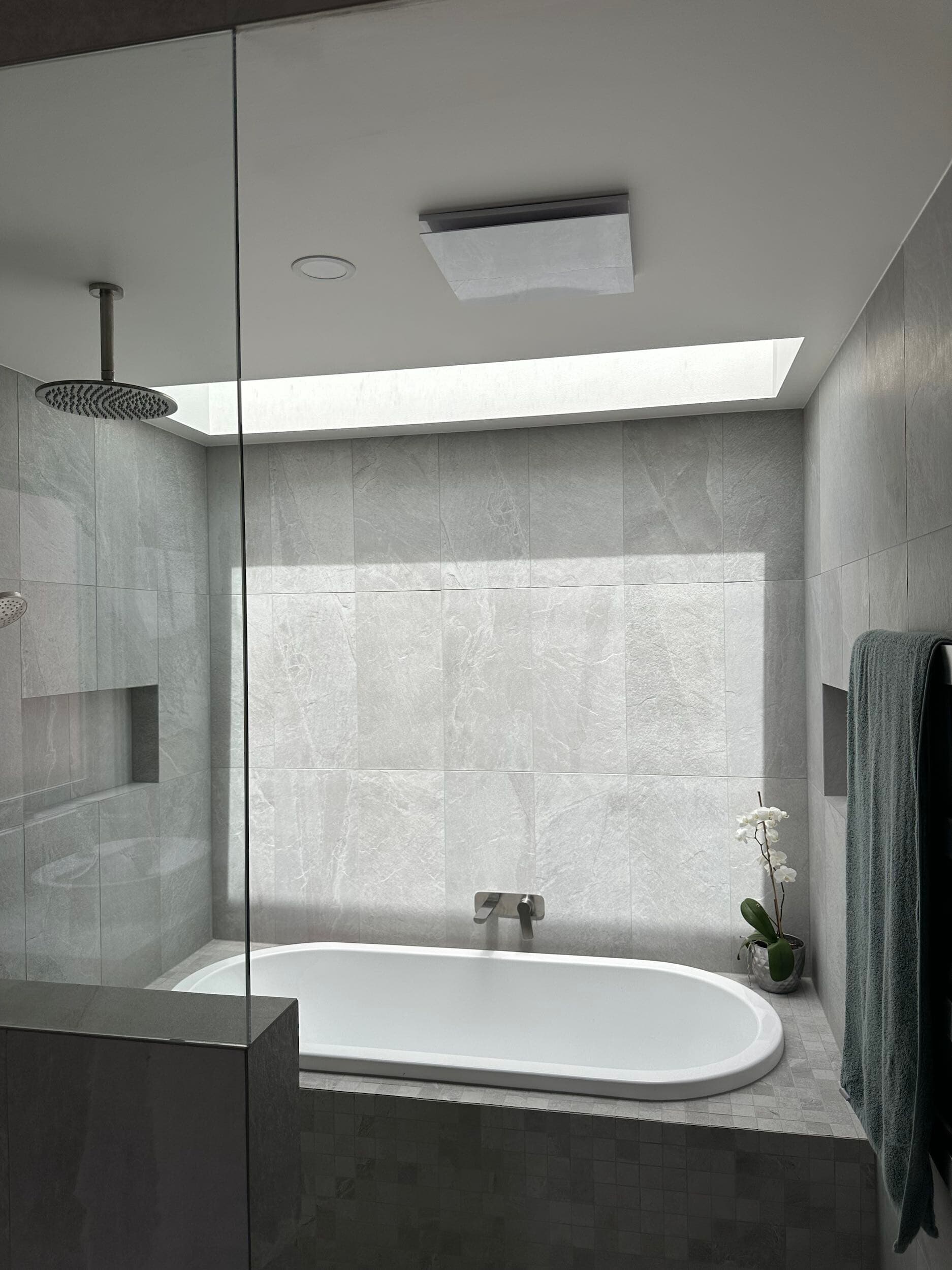 Modern bathroom renovation in Canberra with freestanding tub and marble tiles