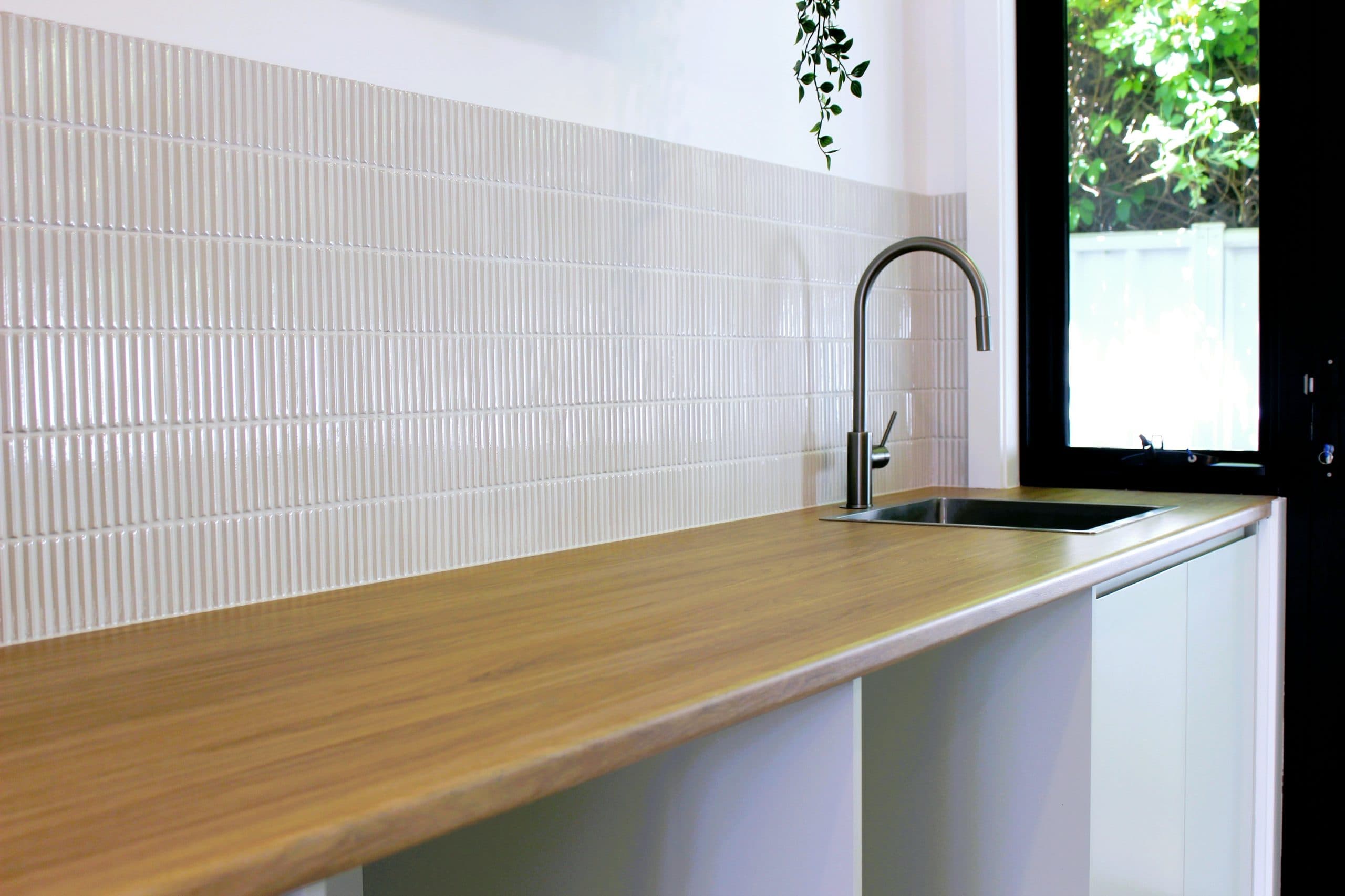 Modern kitchen renovation in Canberra with wooden countertop and stylish backsplash