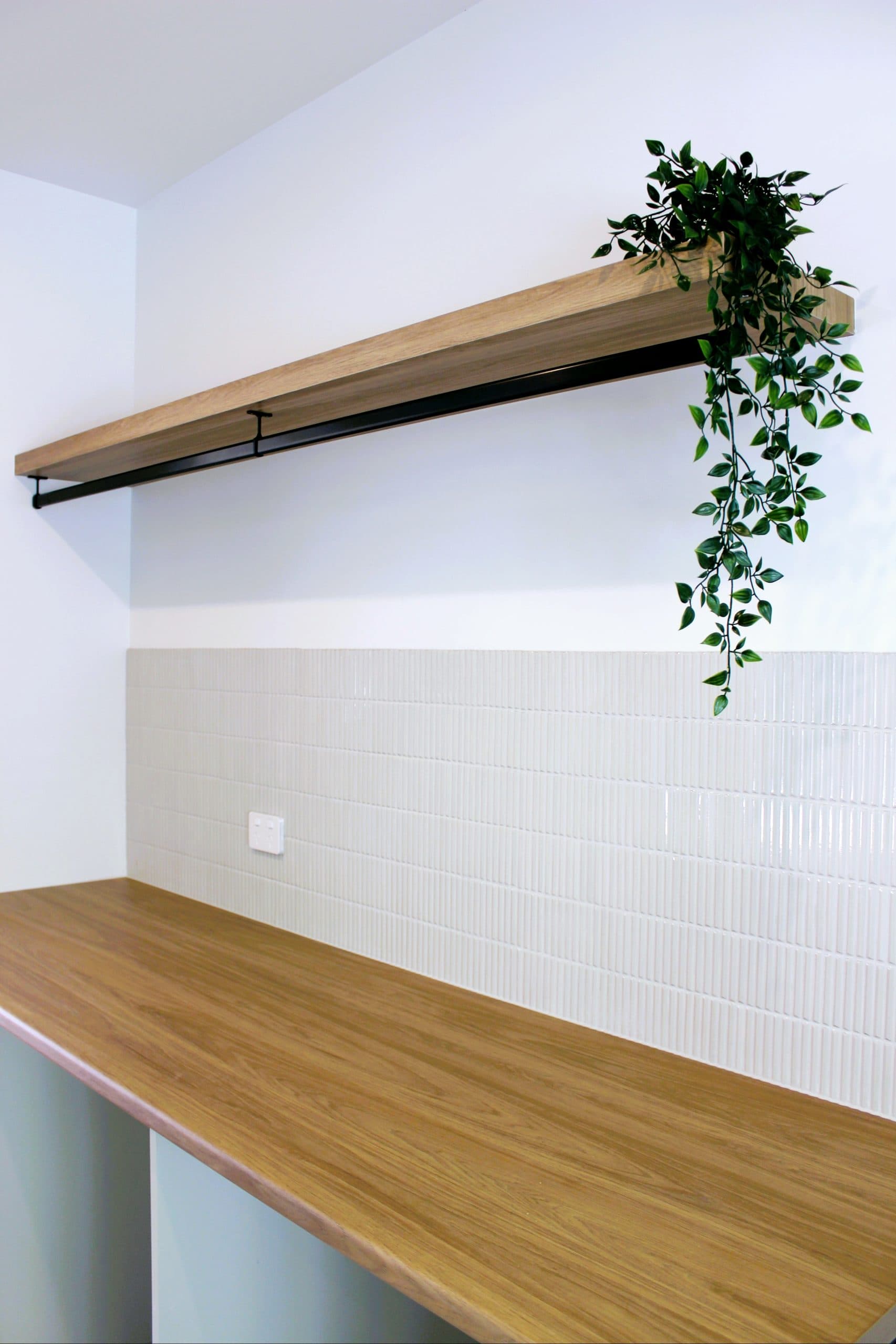 Modern kitchen design in Canberra with wooden countertop and stylish backsplash