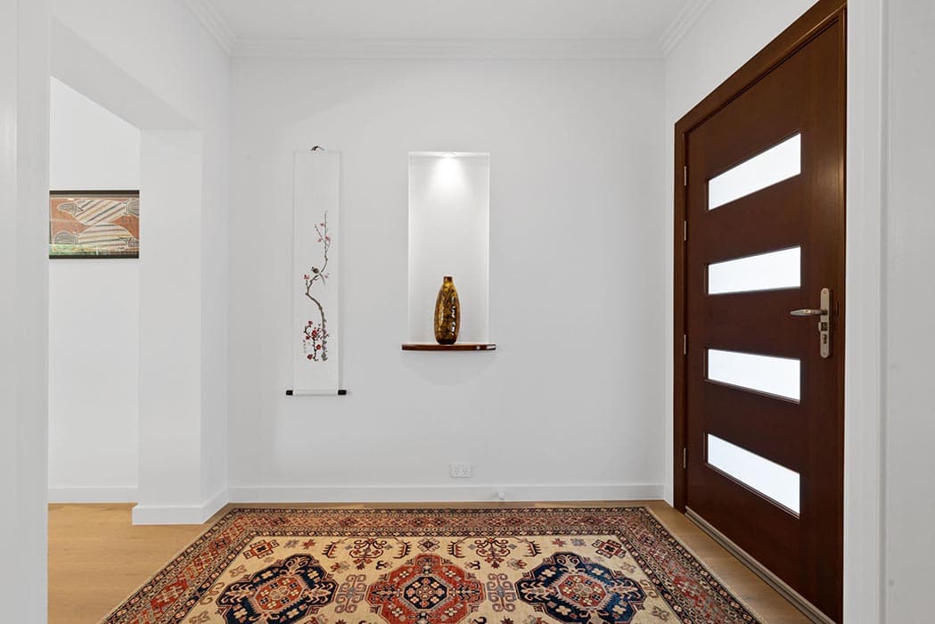 Modern entryway renovation in Canberra, Australia with wooden door and decorative elements