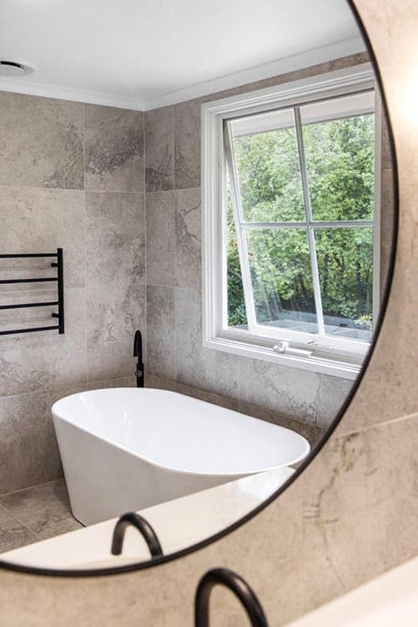 Modern bathroom renovation in Canberra with freestanding tub and elegant finishes